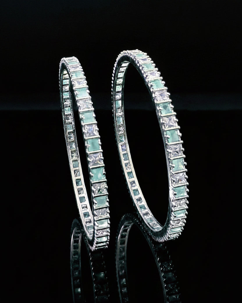 Pair of diamond-studded earrings on a black background