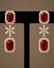 CZ earrings with large ruby red rectangular stones on a black background