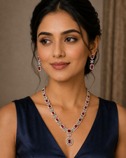 Woman in a navy top wearing a white CZ statement necklace and matching earrings