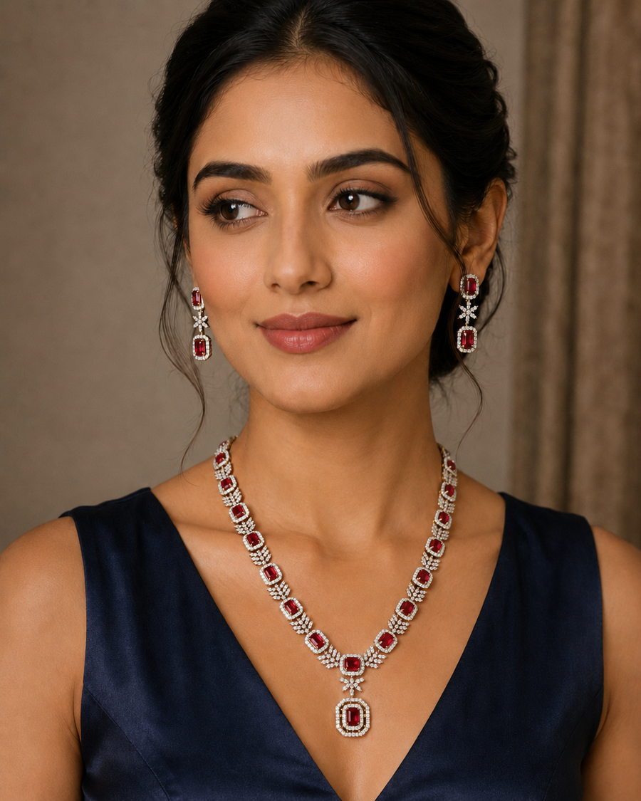 Woman in a navy top wearing a white CZ statement necklace and matching earrings