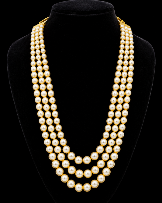 A gold-plated jewelry set featuring a multi-strand pearl necklace and matching drop earrings, displayed on a black velvet mannequin bust.