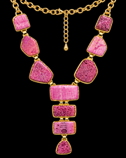 Raw pink agate Y-shaped statement necklace on a black background