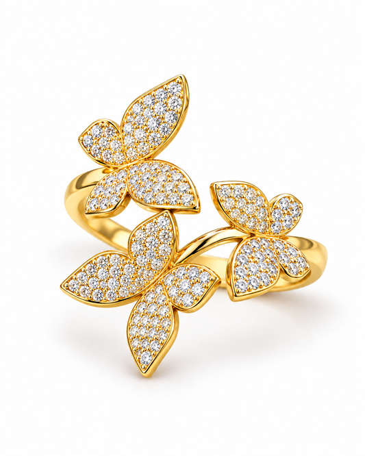 A gold butterfly ring set with pavé diamonds on a clean white background.