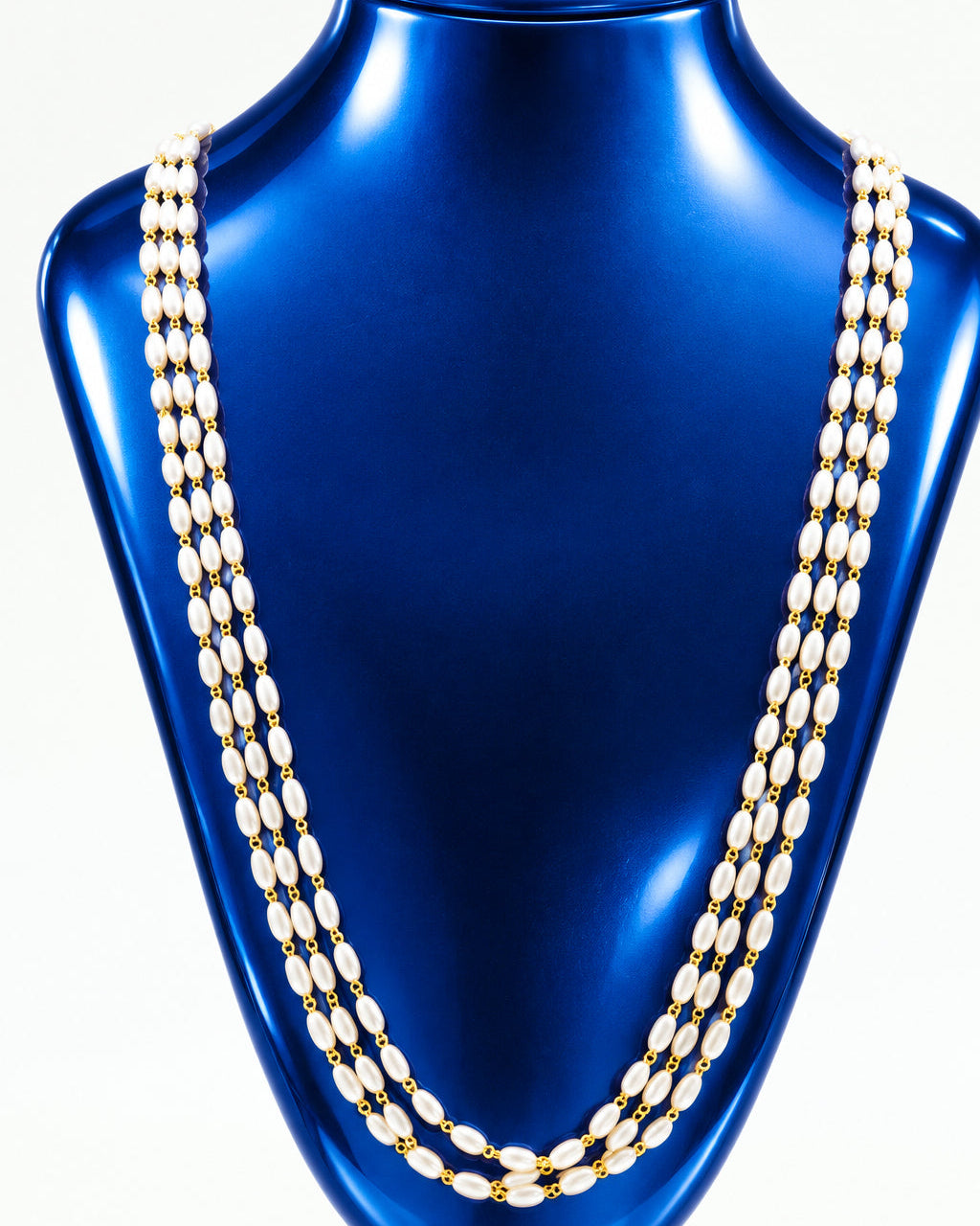 A gold-toned multi-strand chain necklace displayed on a black velvet jewelry bust against a plain white background.