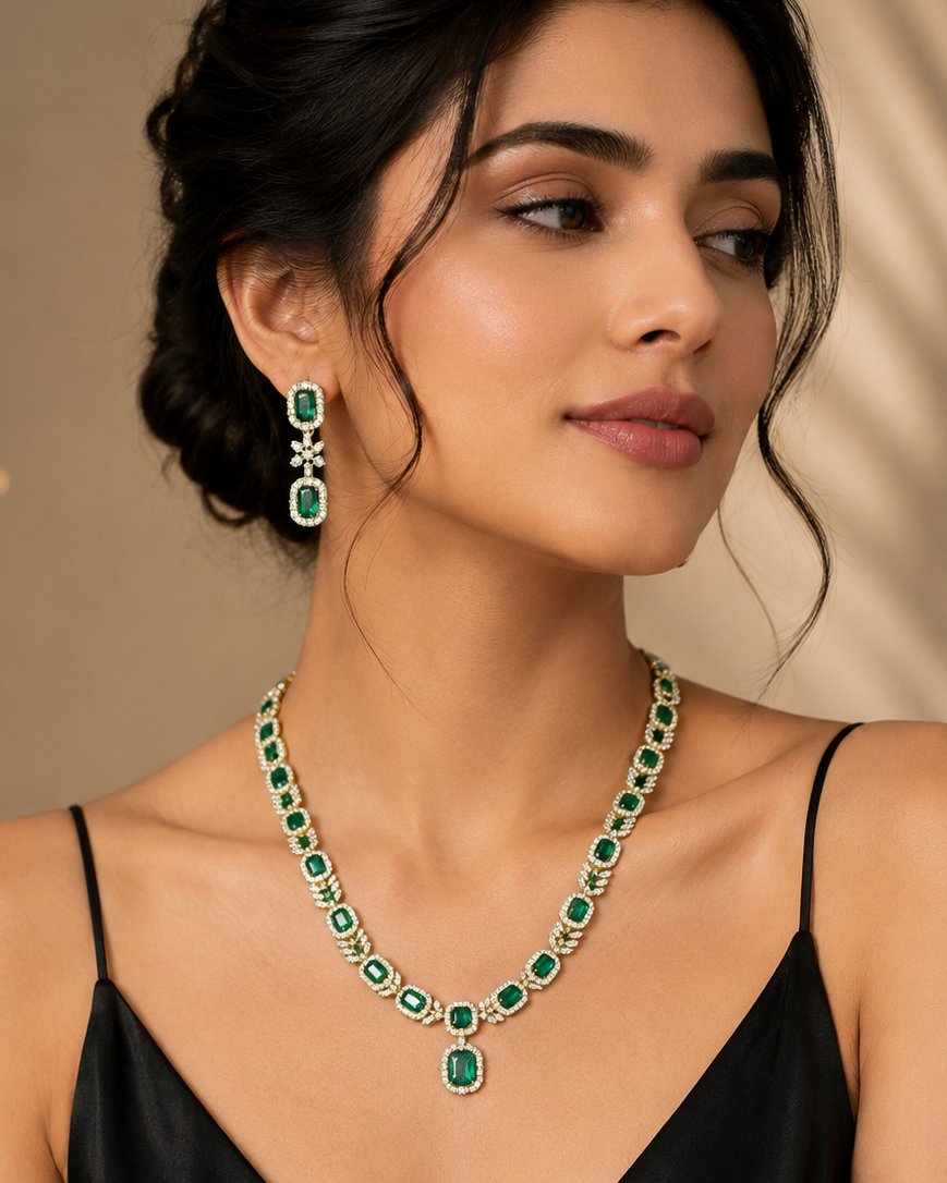 Woman in black wearing a fine green stone necklace with matching earrings