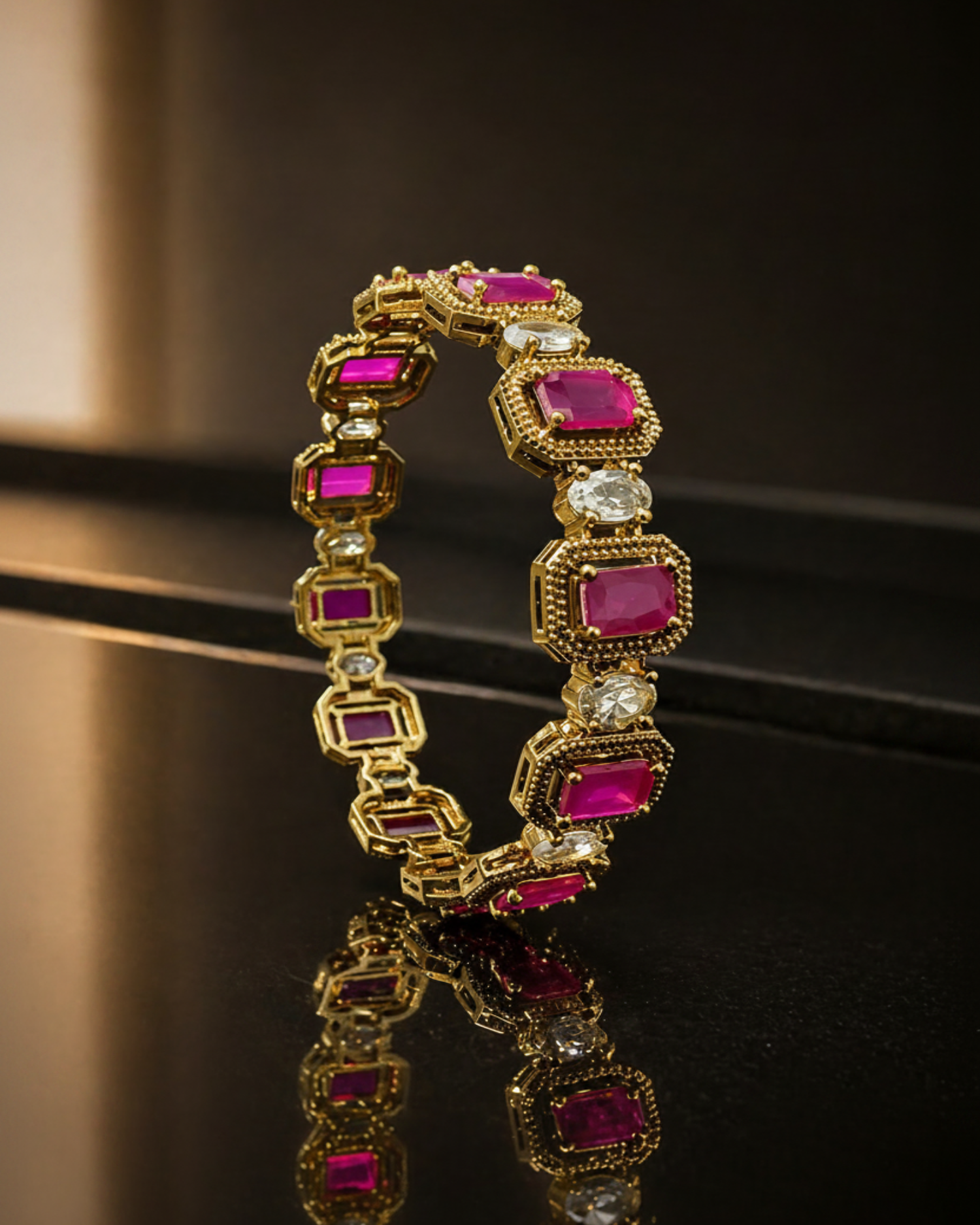 Close view of a gold Victorian bangle set with pink AD stones