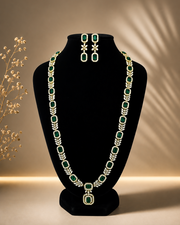 Layered white CZ statement necklace with matching earrings on a black bust