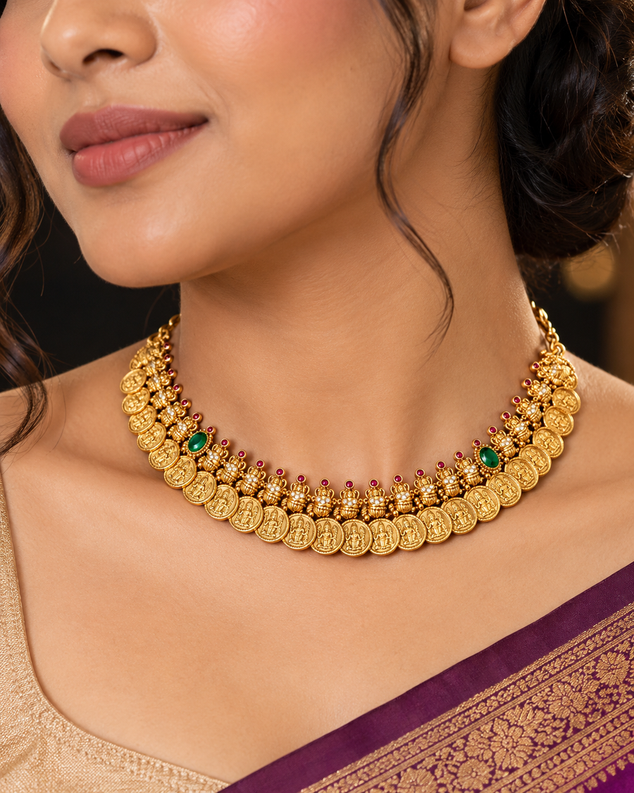 Woman in a maroon saree wearing the gold coin trio necklace